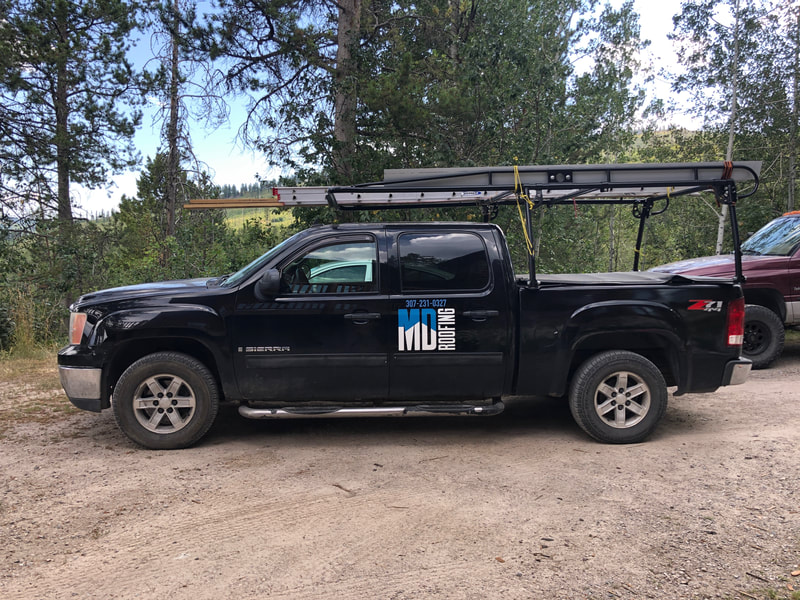 Black work truck with MD Roofing logo